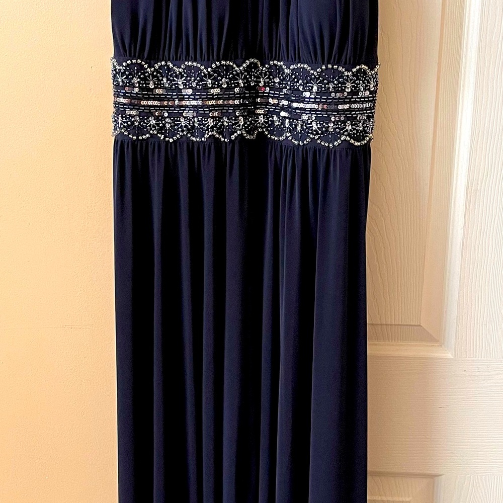 Woman full length gown. Slit up the front.  Beaded empire
